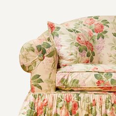 an upholstered chair with pink flowers on it