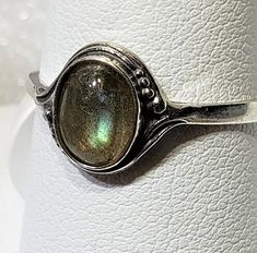 Magical Natural labradorite silver 925 mark ring szs 4-12 cabochon stone size 6 x 8 mm gift box included A semi-precious stone is also known as a gem or gemstone (also a jewel, a gem, a precious stone), which is a portion of mineral, which, in refined and cut form, is used to create jewelry or other embellishments. There are also organic resources or precise rocks that are not minerals (for example jet or amber) that are also used for jewelry and would also be considered to be gemstones, as well Spiritual Adjustable Jewelry With Round Stone, Antique Sterling Silver Oval Cabochon Jewelry, Silver Oval Gemstone Cabochons, Silver Oval Cabochon Jewelry With Bezel Setting, Sterling Silver Jewelry With Oval Cabochon, Sterling Silver Jewelry With Bezel Set Oval Cabochon, Oval Sterling Silver Jewelry Stamped 925, Oval Cabochon Moonstone Jewelry, Adjustable Nickel-free Moonstone Ring As Gift