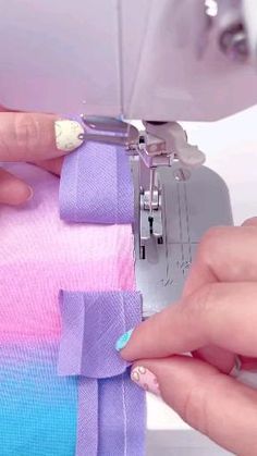 someone is using a sewing machine to sew something on the side of a piece of fabric