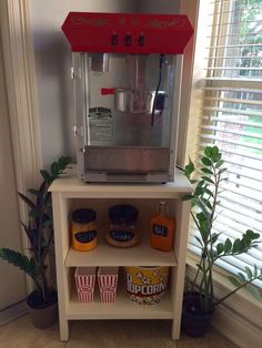 a coffee machine sitting on top of a white shelf