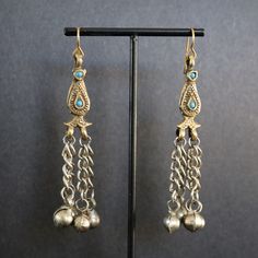 Long Brass and Silver Earrings. These dangling beauties are featured in antique brass and silver.  Sweet little bells are featured on the bottom.  Fabulous to wear with your favorite dress or delightful with jeans.  Light weight, easy to wear, 3.00" x 1.00".  Ear wires are raw brass.  They will arrive in a gift box.  Fun unique earrings for a Bohemian or Ethnic Vibe. *SIZE* Length is 3.00 inches Width is 1 inch *FREE SHIPPING* I will get your lovely in the mail within 24 to 48 hours. Shipping is Monday through Friday and mailed USPS first class or priority mail. Tracking number will be sent to you. For more delights from Mystic Pieces: Antique Brass Earrings: https://www.etsy.com/shop/mysticpieces?ref=seller-platform-mcnav&section_id=41887531 Gold Earrings: https://www.etsy.com/shop/mystic Festival Dangle Beaded Earrings For Pierced Ears, Festival Beaded Dangle Earrings, Metal Earrings With Dangling Beads For Festivals, Metal Dangle Plug Earrings For Festivals, Festival Drop Earrings With Dangling Beads, Traditional Long Drop Earrings For Pierced Ears, Traditional Long Drop Earrings With Dangling Beads, Traditional Long Drop Jewelry With Dangling Beads, Traditional Teardrop Dangle Earrings