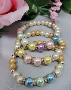 This handmade pearl and crystal glass bead bracelet is comprised of High Quality Glass White and Light Gold (Ivory) Crystallized Pearls, 8mm Birthstone Colored Glass Crystal Pearls, silvertone plated Crystal Rondelle Spacers. The bracelet pictured is a size 7.25" and is made with strong, durable, quality stretch cord for comfortable and easy wear. This will be shipped in a gift sash bag or gift box and a bubble envelope.  **Please remember sales tax is collected by Etsy depending upon your location and will be added at checkout...thank you! Thanks for stopping by and have a great day! Colors may vary depend upon your screen divice/monitor. This product is intended for adult use only.  CHOKING HAZARD WARNING: This jewelry is Not intended for young children.  Babies and young children may ch Silver Pearl Beaded Bracelets With Colorful Beads, Pearl Beaded Bracelets With Silver Beads, Pearl Crystal Bracelet With Faceted Round Beads, Silver Pearl Bracelet With Colorful Beads, Silver Beaded Pearl Bracelets, Elegant Pearl Bracelet With Colorful Beads, Silver Pearl Bracelets With Colorful Beads, Elegant Pearl Bracelets With Colorful Beads, Elegant Silver Pearl Bracelet With Colorful Beads