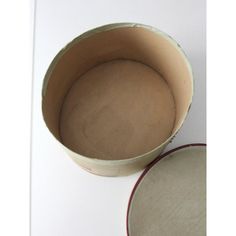 an empty bowl sitting on top of a white table next to a red and white plate