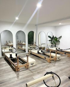 a room with mirrors, benches and exercise equipment on the floor in front of them