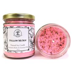 a pink candle next to a glass jar filled with it's own product, follow me boy