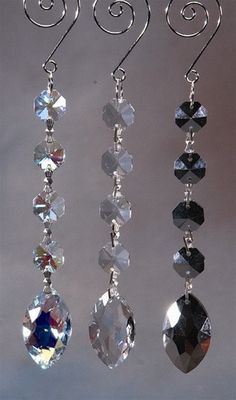 three pairs of crystal earrings hanging from hooks