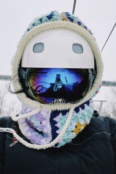 a person wearing a ski helmet and scarf