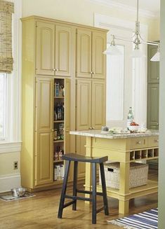 a kitchen with an island and stools in it