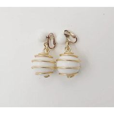 Goldtone and white balls spiral clip back earrings. Marked "Trifari." From Trifari's Parisphere line. Identical earrings were featured in a 1954 advertisement. Measure: 2 inches long by 0.88 inches wide. Condition: Very Good; wear to backs & one jump ring. White Retro Earrings For Formal Occasions, Retro White Earrings For Formal Occasions, White Retro Formal Earrings, Retro White Dangle Jewelry, Retro White Dangle Earrings, Retro White Drop Earrings, White Retro Clip-on Earrings As Gift, Retro White Clip-on Earrings As Gift, Vintage Clip-on White Gold Earrings