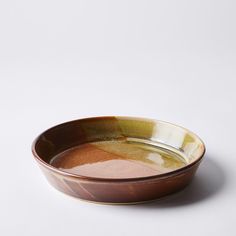 a brown and white bowl sitting on top of a table