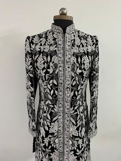 Garb yourself in a stunning masterpiece by Sherwanionline.This sherwani is meticulously handcrafted on a raw silk material in black colour. It has detailed and continuous white thread handwork. It has a mandarin collar which is highlighted with contrasting embroidery.This sherwani not only accentuates your personal style quotient but also fits into everything conventional and heirloom. Includes- sherwani and bottom  Colour options available. Customisation available. Dad Outfits, Mens Ethnic Wear, Suit For Men Wedding, Reception Outfits, Men's Ethnic Wear, Suit Designs, Silk Material, Black Colour, Mens Costumes