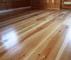 an empty room with wooden floors and wood paneling