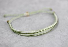 Multi colored string bracelet of sage green, pastel green and natural can be worn anywhere! Waterproof boho chic friendship bracelet can be worn to the pool, at the beach, working out or in the shower. Colorfast so won't fade when wet. Wear this adjustable bracelet alone or stacked with others for a fun layered look! Have different colors in mind? Convo me for a custom order! I'd be happy to make one just for you! A31 Adjustable Green Bracelets For Everyday, Green Bohemian Bracelets For Summer, Minimalist Adjustable Green Friendship Bracelets, Everyday Adjustable Green Bracelets, Green Bohemian Bracelets With Adjustable Cord, Minimalist Braided Bracelets With Sliding Knot For Beach, Adjustable Green Braided Bracelets For Everyday, Minimalist Adjustable Green Bracelets, Green Bohemian Braided Bracelets For Everyday