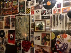 the wall is covered with records and pictures