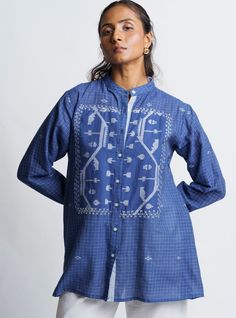 About The CHECK Glory Shirt: Our Blue Check Women's Loose Button-Down Shirt is crafted from beautiful handloom jamdani fabric, lovingly made by skilled artisans from West Bengal, India. This shirt features a stylish mandarin collar, a refined placket, and full sleeves with contrasting stripes at the collar, placket, and cuffs. ✔️ Highlights include the intricate jamdani border detail at the yoke, enhanced with delicate white machine embroidery, adding a unique touch of elegance. ✔️ Ideal for eve Cotton Tunic Blouse With Buttons, Relaxed Fit Plaid Blouse For Daywear, Plaid Cotton Button-up Blouse, Plaid Blouse With Button Closure And Relaxed Fit, Oversized Plaid Blouse For Spring, Relaxed Fit Plaid Blouse With Button Closure, Plaid Relaxed Fit Blouse With Button Closure, Relaxed Fit Plaid Top With Buttons, Casual Cotton Button-up Tunic