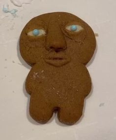 a cookie shaped like a bear with blue eyes