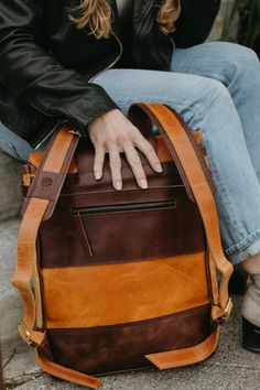 This Leather Backpack is the perfect way to travel for your meetings, work trips or everyday errands!Dimensions:14" W x 17" HFeatures:• Fits 13" laptop• Interior slots and zipper pocket• Exterior zipper pocket on back• Natural brass closures• Adjustable Leather straps Standard Backpack With Laptop Sleeve For On-the-go, Brown Backpack With Zipper Pocket For On-the-go, Standard Backpack With Laptop Sleeve For Daily Use, Laptop Backpack With Zipper Closure For Travel, Standard Travel Laptop Bag With Laptop Sleeve, Travel Laptop Bag With Sleeve In Standard Backpack Shape, Laptop Backpack With Zipper For Trips, Travel Laptop Bag With Sleeve, Travel Laptop Bag With Laptop Sleeve