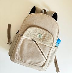 Himalayan Natural Hemp Backpack by Namaste Creation Craft.  Discover our eco-friendly backpack crafted from a blend of organic Himalayan cotton and sustainable hemp. Each backpack, sized at 15 x 11 inches, is lightweight and ideal for your adventures. Handmade using traditional methods and natural dyes, each piece is unique and ethically crafted, supporting Nepalese farmers. Proudly made in Nepal, this backpack is a statement of our commitment to sustainability. Our backpack are Perfect for ever Eco-friendly Beige Backpack, Recyclable Backpack For Travel, Recyclable Backpack For Outdoor Use, Eco-friendly Backpack For Outdoor, Eco-friendly Outdoor Backpack, Eco-friendly School Backpack With Adjustable Strap, Eco-friendly School Backpack, Eco-friendly Rectangular Travel Backpack, Recyclable Everyday Backpack