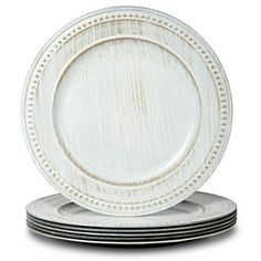 four white plates stacked on top of each other