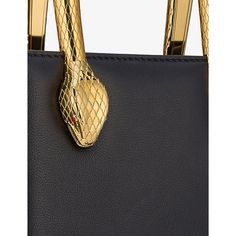 Find BVLGARI Serpenti Leather Tote Bag on Editorialist. This Bvlgari tote bag is crafted from 100% calf leather. It features a gold-toned serpent head embellishment and a top handle. It measures 17.5 centimeters in height, 14 centimeters in width, and 5.5 centimeters in depth. The bag is made in Italy and requires specialist leather cleaning. Bvlgari Bag, Bvlgari Serpenti, The Serpent, Black Leather Tote Bag, Mary Katrantzou, Shoes Heels Pumps, Trainer Boots, Leather Cleaning, Boots Knee