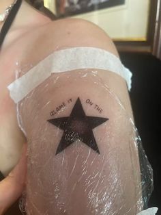 a person with a black star on their thigh that says, please it on the side