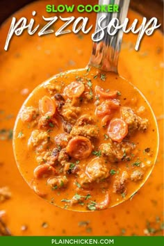 a ladle full of soup with meatballs and tomatoes in it, ready to be eaten