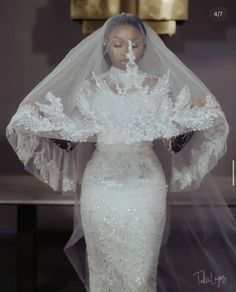 a woman in a white wedding dress and veil