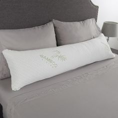 a close up of a pillow on a bed with the company logo printed on it