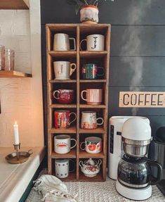 a coffee maker sitting on top of a counter next to a shelf filled with cups