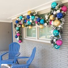 two blue chairs sitting in front of a window with christmas decorations on the windowsill