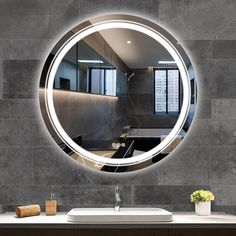 a bathroom sink under a round mirror