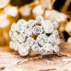 a diamond ring sitting on top of a rock