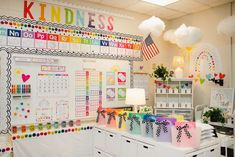 an office decorated in rainbows and white with lots of colorful decorations on the wall