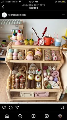 a wooden shelf filled with lots of different types of donuts and other items on top of it