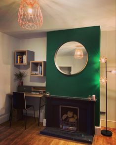 a living room with a fire place and a mirror on the wall next to it