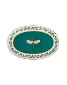 a green and white plate with two pink butterflies on the side, in front of a white background