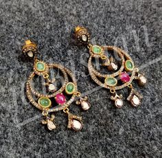 Brand- Jai Kishan Jewellers Item- 925 Sterling Silver Polki Pave Diamond Emerald Ruby Gemstone Earring Diamond- Polki And Pave Diamond Gemstone- Emerald & Ruby Earring color- Gold And Black Type- Earring Manufacturing- India Information We are manufacturing all kinds of jewelry. If you have any queries please contact us. We are Happy To Help You. Elegant Pendant Earrings With Stone Setting, Fusion Style Hand Set Dangle Earrings, Fine Jewelry Multi-stone Round Diamond Earrings, Green Diamond Multi-stone Earrings, Green Multi-stone Diamond Earrings, Hand Set Fusion Dangle Earrings, Traditional Pendant Earrings With Stone Setting, Hand-set Dangle Fusion Earrings, Fusion Style Silver Earrings With Stone Setting