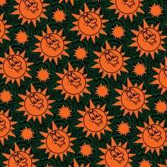 an orange and black background with stars and sun's faces in the center, on top of green leaves