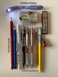 the contents of an electronic device laid out on top of a table with pens and markers