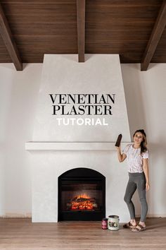 a woman standing in front of a fire place