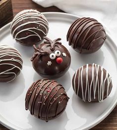 chocolate covered donuts decorated like reindeers on a plate