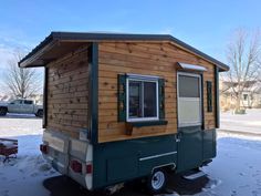 a tiny house is parked in the snow