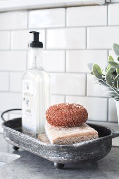 a loaf of bread sitting on top of a pan next to a bottle of soap