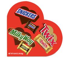 the heart shaped box is filled with different types of candy