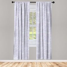 a window with polka dots on it in front of a white wall and wooden floor