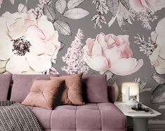 a living room with floral wallpaper and purple couch