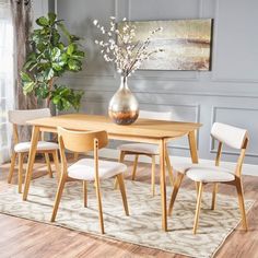 a dining room table with four chairs around it