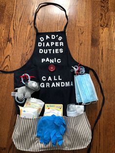 a child's apron that says dad's diaper duties panic call grandma