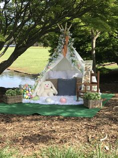 a teepee tent is set up in the grass