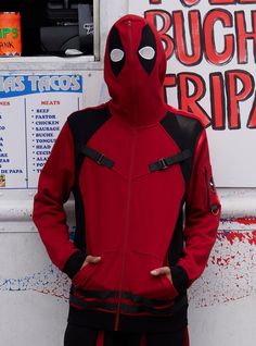 a man in a deadpool costume standing next to a food truck with his hands on his hips